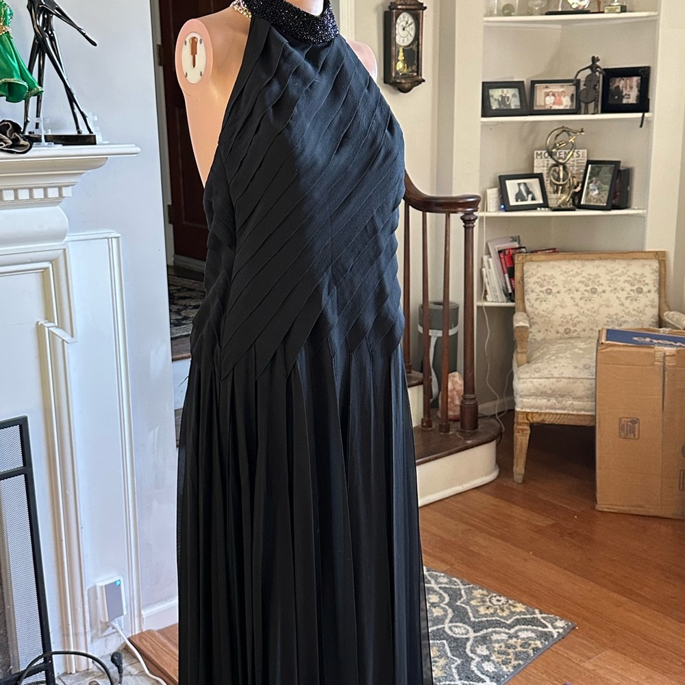Mon Cheri Black halter gown with open pleating. Beaded collar.Pleated Maxi Dress